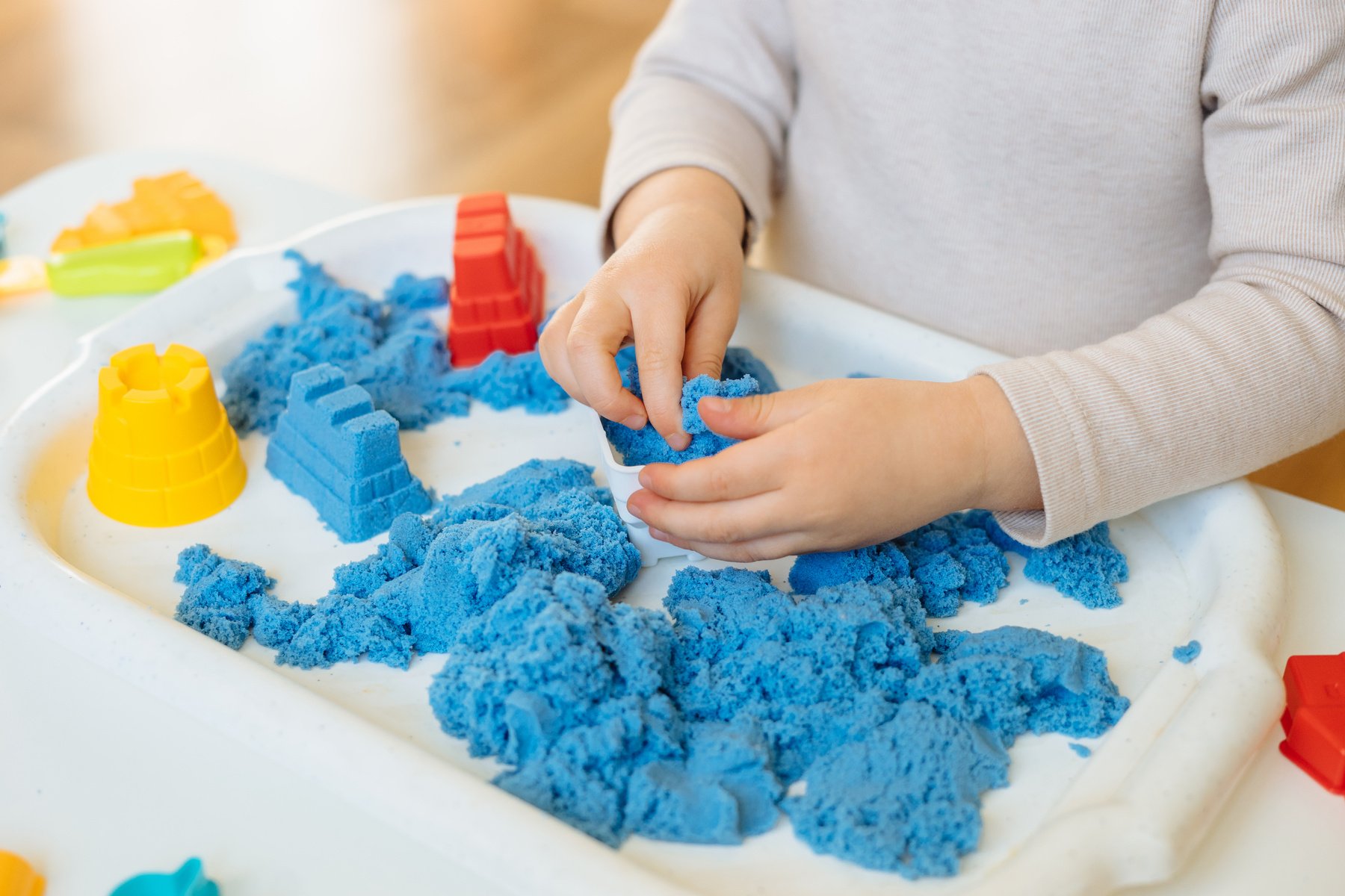 Closeup of Child's Hands Playing with Kinetic Sand